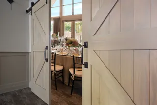Doors opening to a table in a sundrenched room