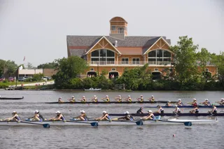 Rowers in front of the boathouse